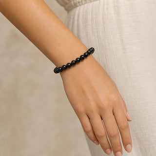 Black tourmaline bead bracelet worn on a wrist