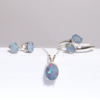 Opal earrings, pendant and ring set in silver