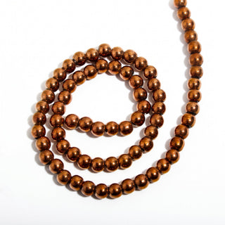 Copper Hematite Bead Strand (Enhanced) — BE6cDSC142966, new photo on a clean white background. Stonebridge Imports.