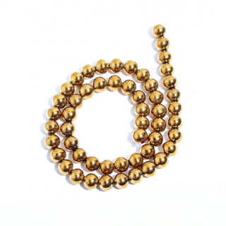 Gold Hematite Bead Strand (Enhanced), new photo on a clean white background. Stonebridge Imports.