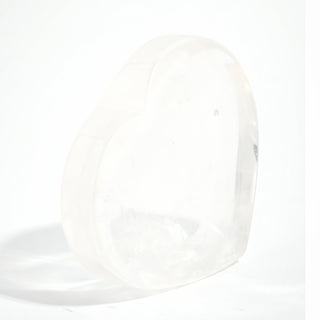 Clear Quartz Heart Bowl standing upright to show the heart outline and the translucency of the clear quartz, on a clean white background. Stonebridge Imports.