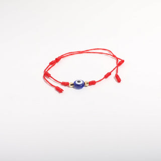 Red-cord bracelet from the Evil Eye Bracelet Adjustable Cord 2 Pack, showing a red waxed cord with a blue-and-white evil eye and gold beads, photographed on a clean white background. Stonebridge Imports.