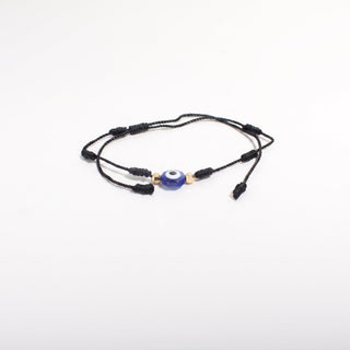 Black-cord bracelet from the Evil Eye Bracelet Adjustable Cord 2 Pack, showing a black waxed cord with a blue-and-white evil eye and gold beads, photographed on a clean white background. Stonebridge Imports.