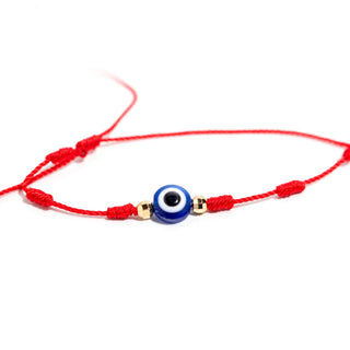 Close-up of the red-cord evil eye bracelet from the Adjustable Cord 2 Pack, showing the blue-and-white glass evil-eye bead and knotted red cord, photographed on a clean white background. Stonebridge Imports.