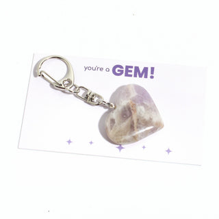 One of the five banded chevron amethyst heart charms from the pack, shown on its "you're a GEM!" gift backing card, hanging from its silver clasp on a clean white background. Stonebridge Imports.