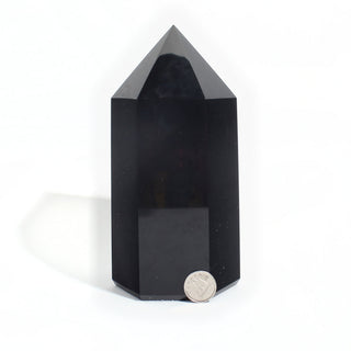 Black Obsidian Generator Unique #5 — polished six-sided tower with a faceted point, beside a Canadian dime for scale, photographed on a clean white background. Stonebridge Imports.