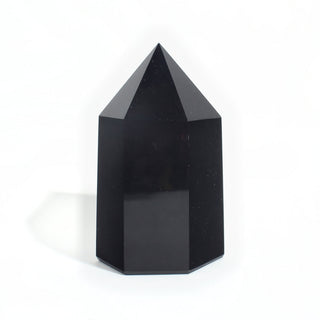 Black Obsidian Generator Unique #8 — polished six-sided tower rising to a faceted point, glossy jet-black faces, photographed on a clean white background. Stonebridge Imports.
