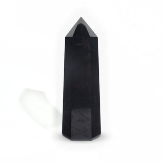 Black Obsidian Generator Unique #11 — polished six-sided tower rising to a faceted point, glossy jet-black faces, photographed on a clean white background. Stonebridge Imports.