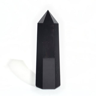 Black Obsidian Generator Unique #11 — polished six-sided tower with a faceted point, seen from a second angle, photographed on a clean white background. Stonebridge Imports.