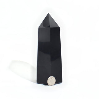 Black Obsidian Generator Unique #15 — polished six-sided tower with a faceted point, beside a Canadian dime for scale, photographed on a clean white background. Stonebridge Imports.
