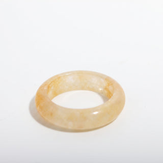 Golden Healer Ring — solid pale golden healer quartz stone band ring, alternate angle photographed on a clean white background. Stonebridge Imports.