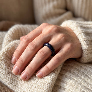 Blue Goldstone Ring (Enhanced) worn on the hand in natural light, showing the solid deep blue goldstone with fine sparkle band at true scale.