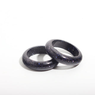 Blue Goldstone Ring (Enhanced) — solid deep blue goldstone with fine sparkle stone band ring, photographed on a clean white background. Stonebridge Imports.