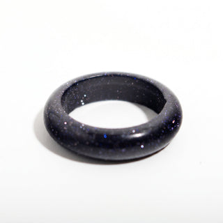 Blue Goldstone Ring (Enhanced) — solid deep blue goldstone with fine sparkle stone band ring, alternate angle photographed on a clean white background. Stonebridge Imports.