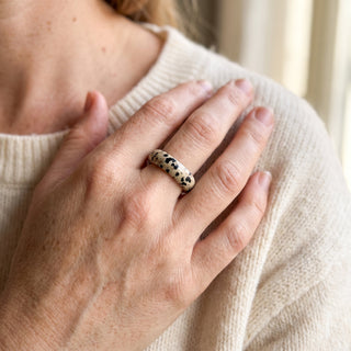 Dalmatian Jasper Ring worn on the hand in natural light, showing the solid cream dalmatian jasper with black spots band at true scale.