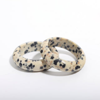 Dalmatian Jasper Ring — solid cream dalmatian jasper with black spots stone band ring, photographed on a clean white background. Stonebridge Imports.