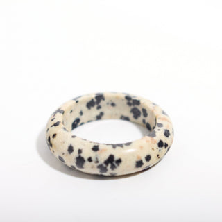 Dalmatian Jasper Ring — solid cream dalmatian jasper with black spots stone band ring, alternate angle photographed on a clean white background. Stonebridge Imports.