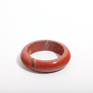 Red Jasper Ring — solid brick-red red jasper stone band ring, alternate angle photographed on a clean white background. Stonebridge Imports.
