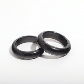 Black Obsidian Ring — solid glossy black obsidian stone band ring, photographed on a clean white background. Stonebridge Imports.