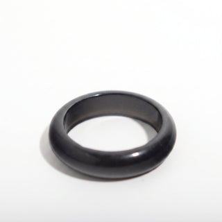 Black Obsidian Ring — solid glossy black obsidian stone band ring, alternate angle photographed on a clean white background. Stonebridge Imports.