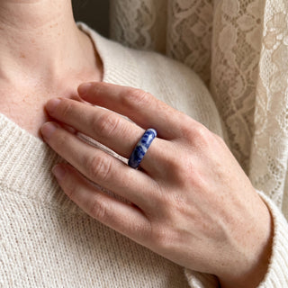 Sodalite Ring worn on the hand in natural light, showing the solid royal-blue sodalite with white veining band at true scale.