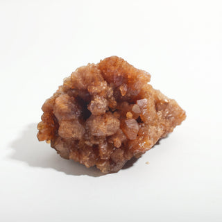 2" — Natural Citrine - Morocco, a chunky honey-brown cluster packed with small glittering crystal points, photographed on a clean white background. Stonebridge Imports.