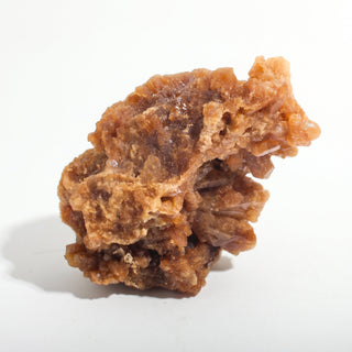 2" — Natural Citrine - Morocco, a larger amber and tan crystal cluster with a rugged, cave-like crystalline face, photographed on a clean white background. Stonebridge Imports.