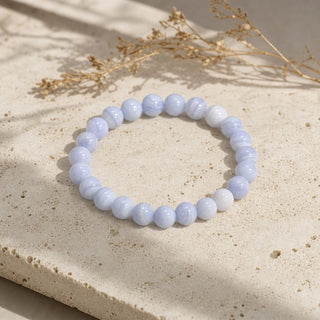 Blue Lace Agate bead bracelet resting on a stone slab