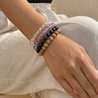 Light Amethyst bead bracelet stacked with other bead bracelets on the wrist