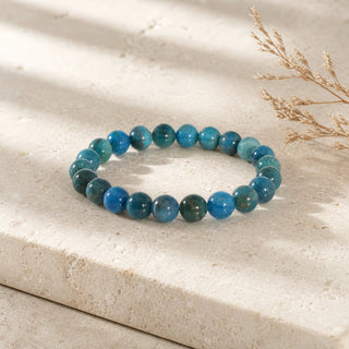 Blue Apatite bead bracelet resting on a stone slab