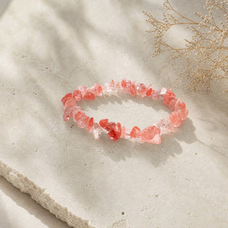 Cherry Quartz bead bracelet resting on a stone slab
