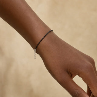 Black Tourmaline bead bracelet worn on the wrist, close-up