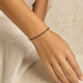 Blue Goldstone bead bracelet worn on the wrist, close-up
