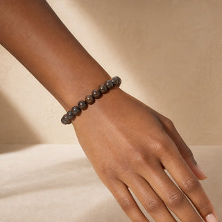 Bronzite bead bracelet worn on the wrist, close-up