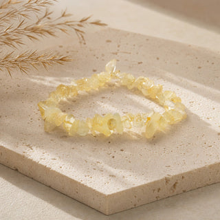 Citrine bead bracelet resting on a stone slab