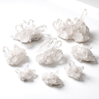 Assortment of natural Brazilian clear quartz 'A' clusters in mini to large sizes on a white background