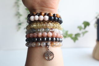 Arm with eight bracelets on it 