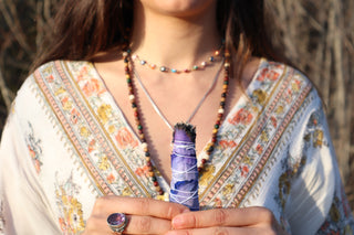 women holding sage stick