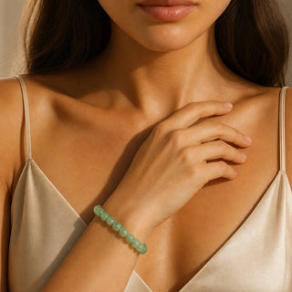 Green Aventurine bead bracelet worn with the hand resting on the chest