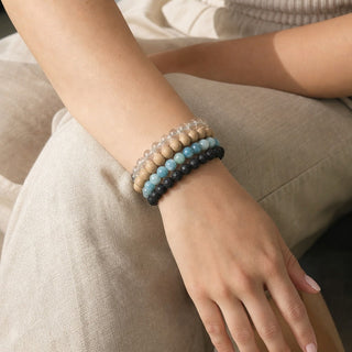 Hemimorphite bead bracelet stacked with other bead bracelets on the wrist