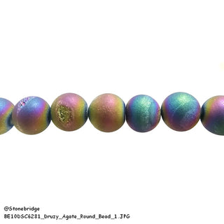 Round rainbow electroplated druzy agate beads show visible crystalline cavities with iridescent blue, purple, and green tones on a white background. Stonebridge Imports.