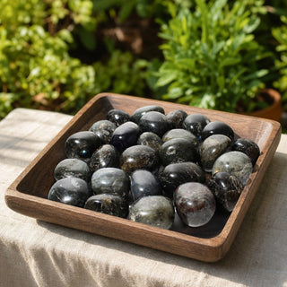 Labradorite A Tumbled Stones - India in a wooden tray at a market stall