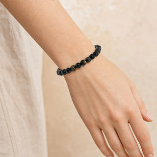 Black Obsidian bead bracelet worn on the wrist, close-up