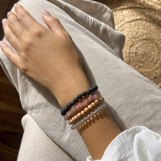 Strawberry Quartz bead bracelet stacked with other bead bracelets on the wrist