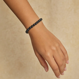 Shungite bead bracelet worn on the wrist, close-up
