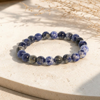 Sodalite bead bracelet resting on a stone slab