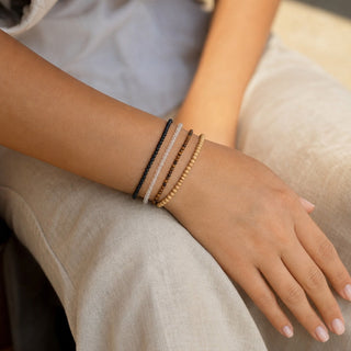 Tiger's Eye bead bracelet stacked with other bead bracelets on the wrist